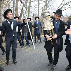 Rabbi with a Torah with others celebrating